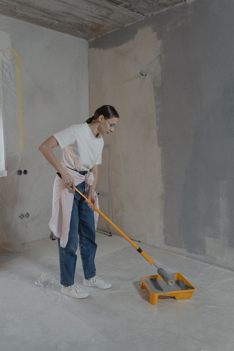 Woman Painting the Wall